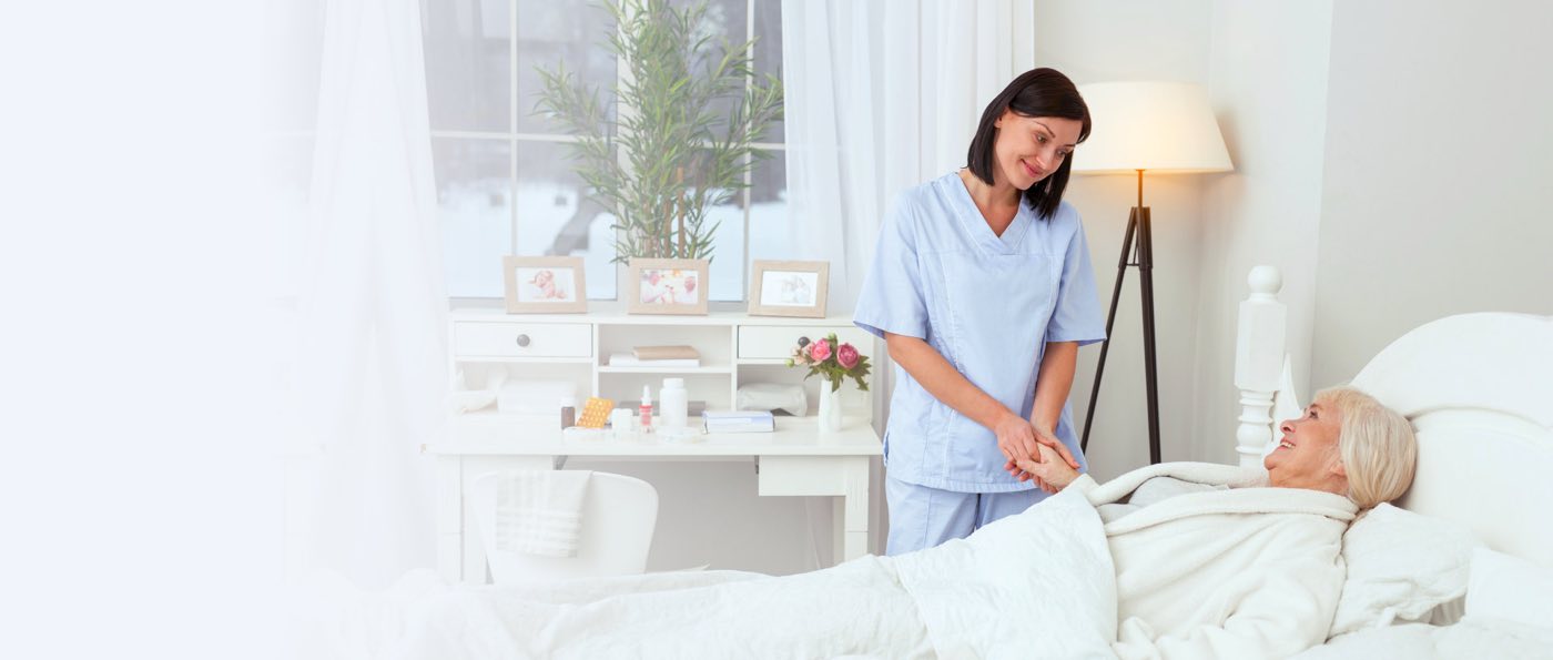Caregiver holding hands of elderly