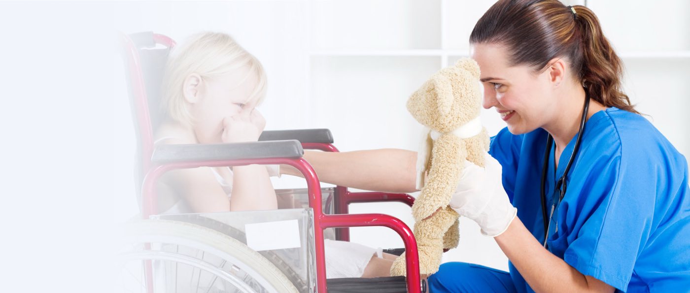 nurse cheering up little girl in wheelchair
