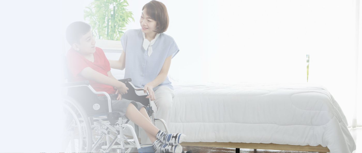 Positive multiracial nurse and child with disability chatting in hospital
